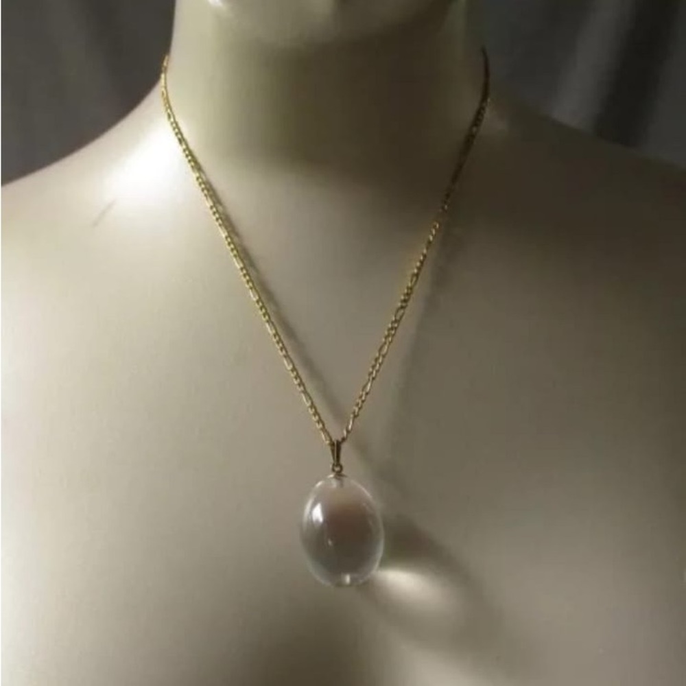Antique rock crystal egg pendent in yellow gold .